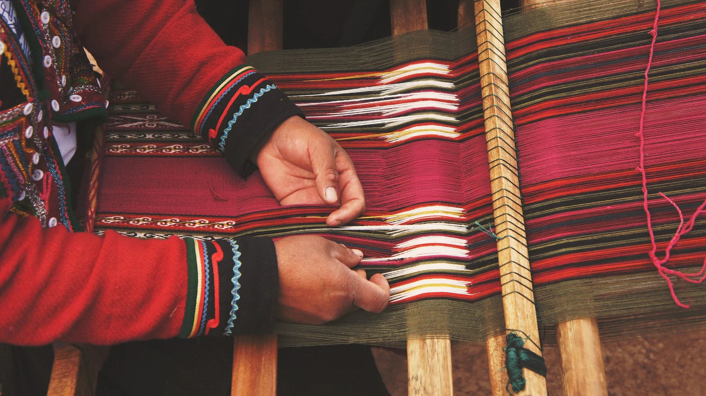 Bolivian craftsman weaving traditional clothes